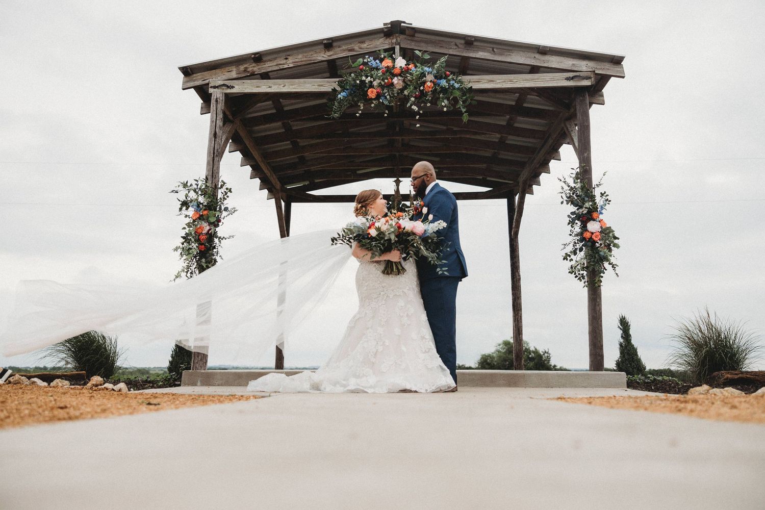 Bride and groom wedding photography outdoor ceremony at he Barn at Wolf Ridge Farm - Gainesville, TX
