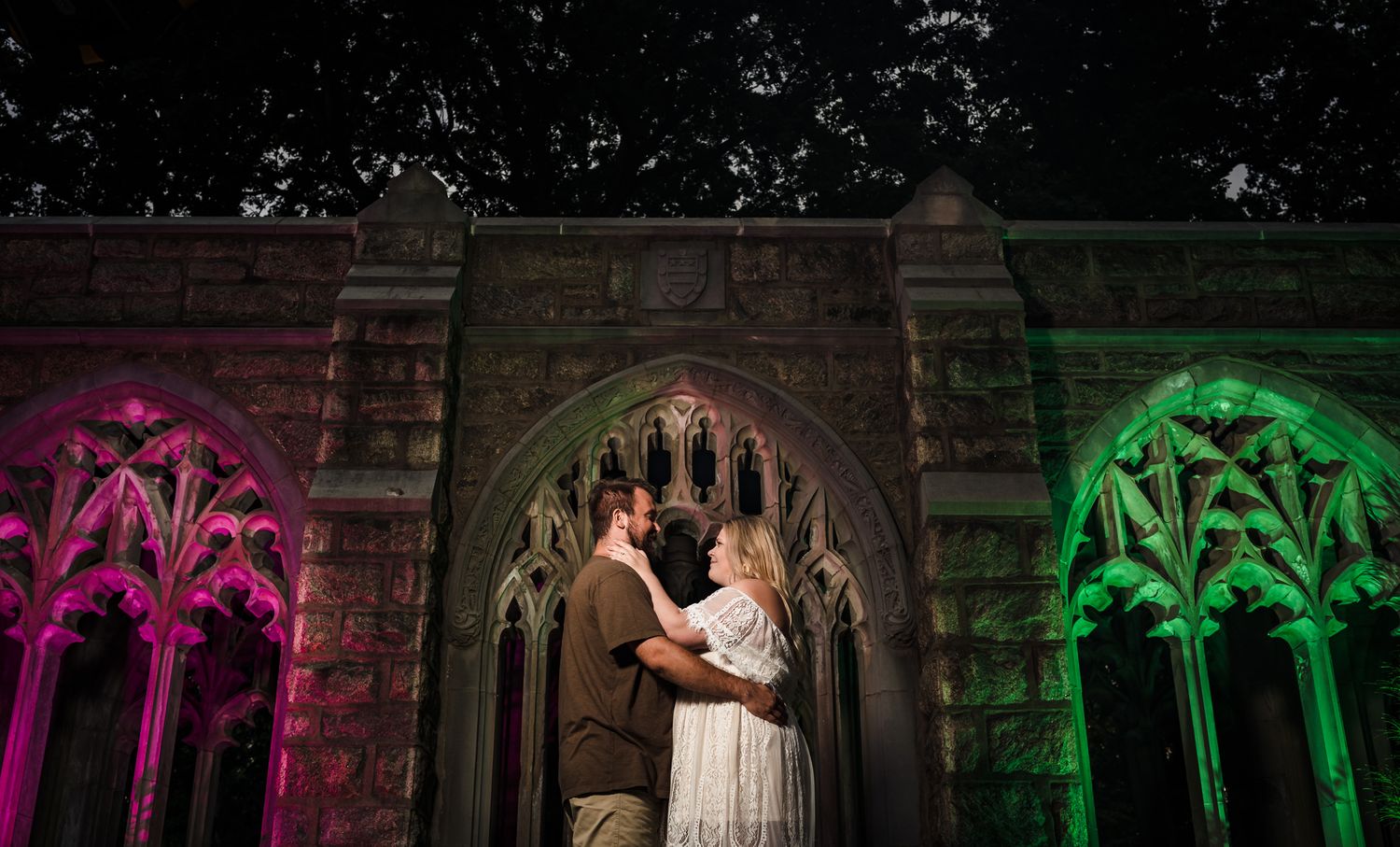 Gothic cathedral interior illuminated with colorful lights creating a dramatic atmosphere.