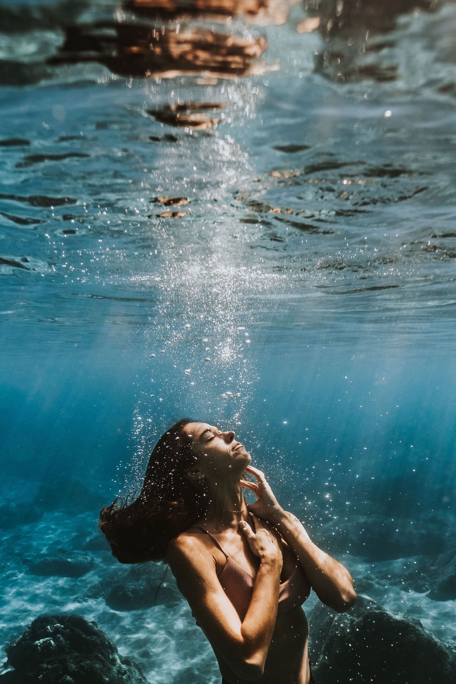 woman posing underwater on Maui