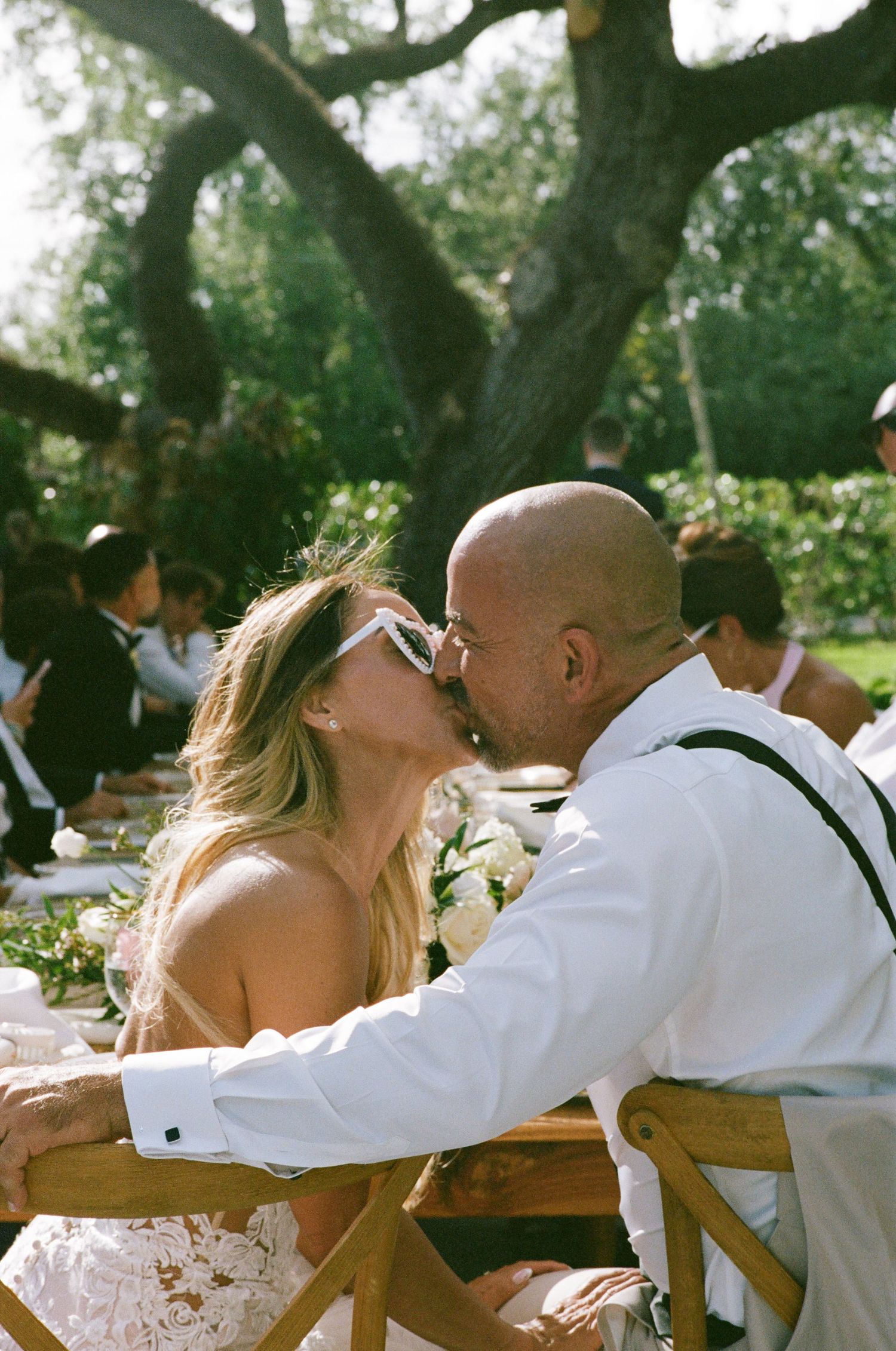 A happy couple sharing an intimate moment during their outdoor garden wedding on a sunny day.