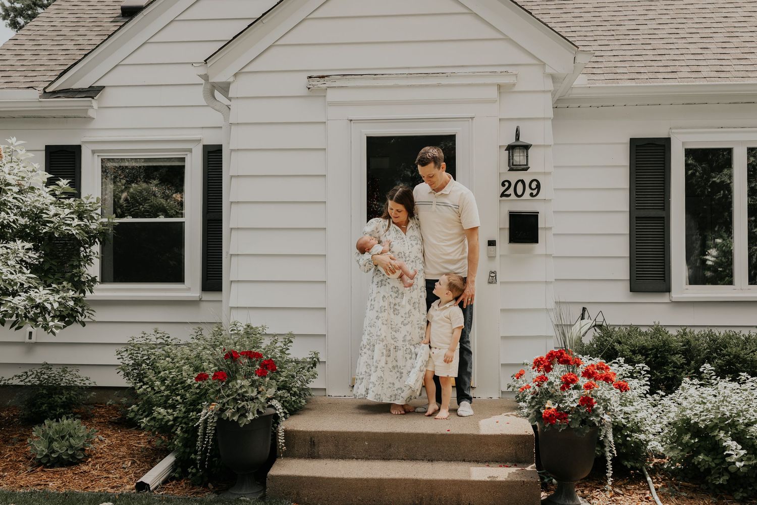 A montage of intimate moments in and around a white farmhouse with trees and red roses in the garden.