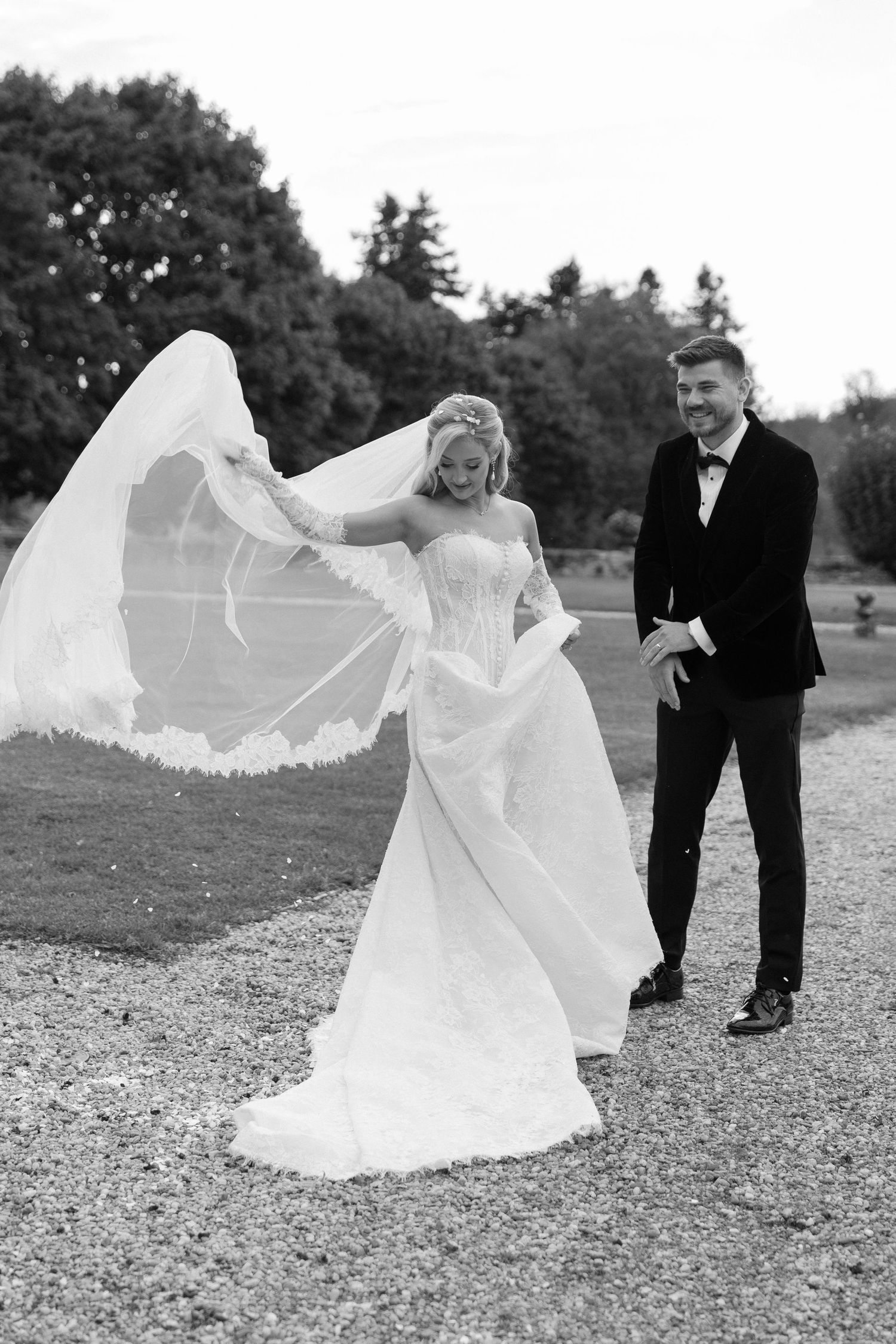 Black and white candid moment of Bride and Groom outside at their french destination wedding, by Maddie Waters Photography