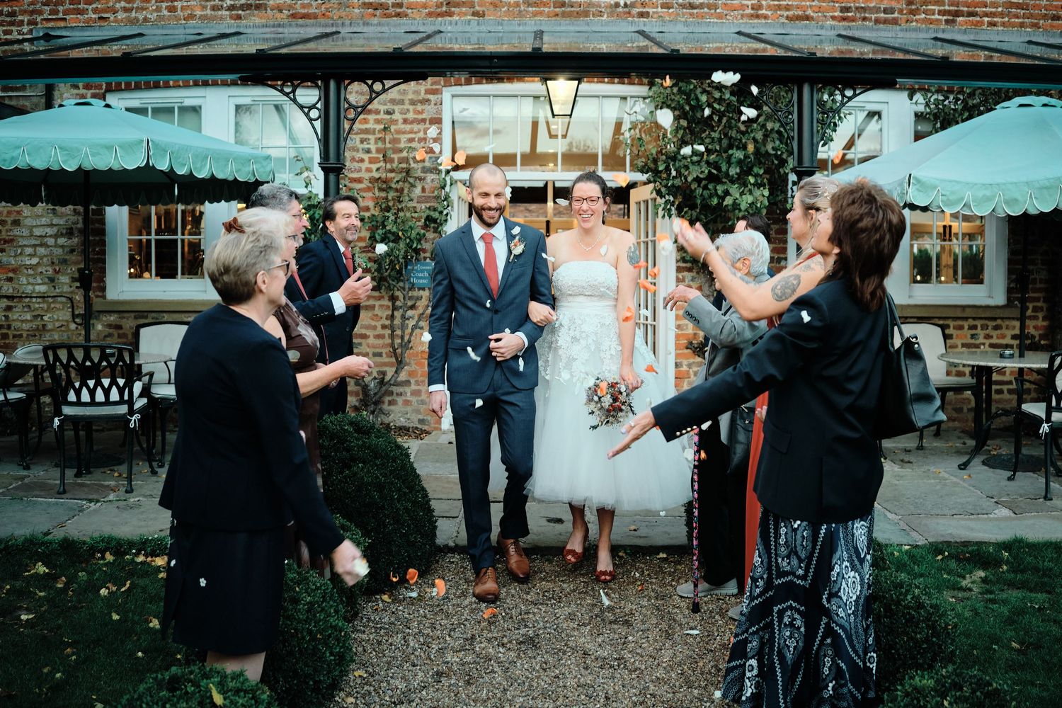 A series of candid moments captured at the Secret Garden wedding venue in Ashford, Kent, during a wedding celebration.