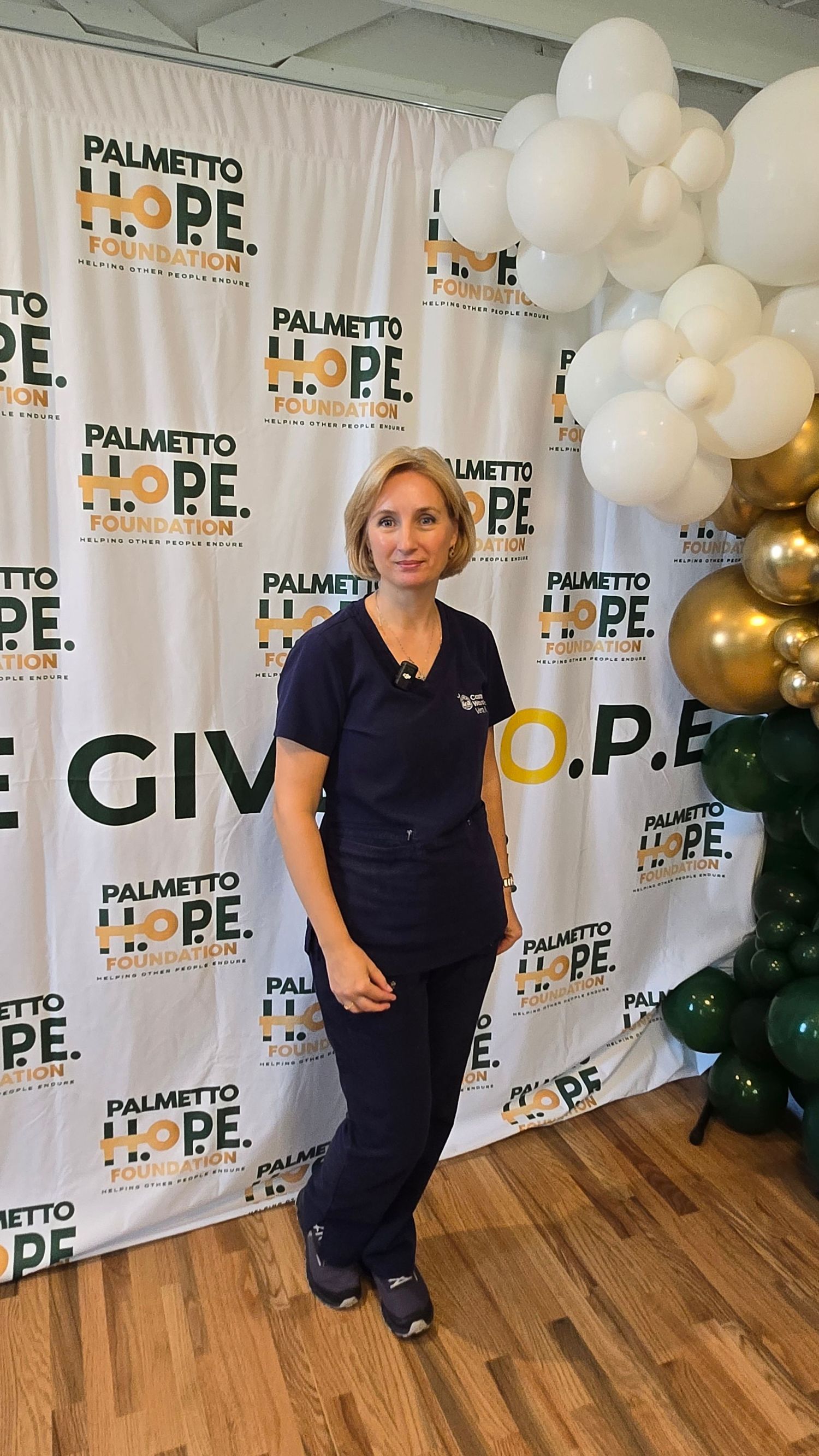 A collage shows four photos with a white backdrop featuring HOPE signage and gold and white balloon decorations.