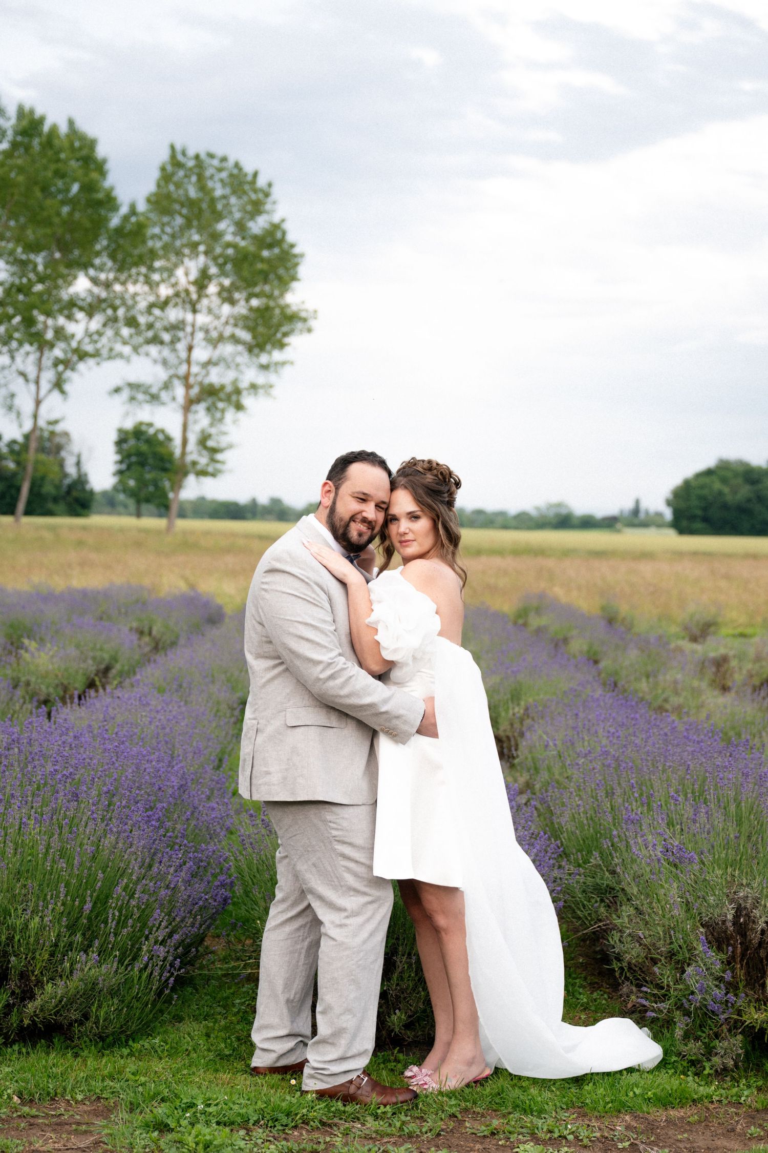 A couple shares tender moments in a beautiful lavender field on their wedding day.