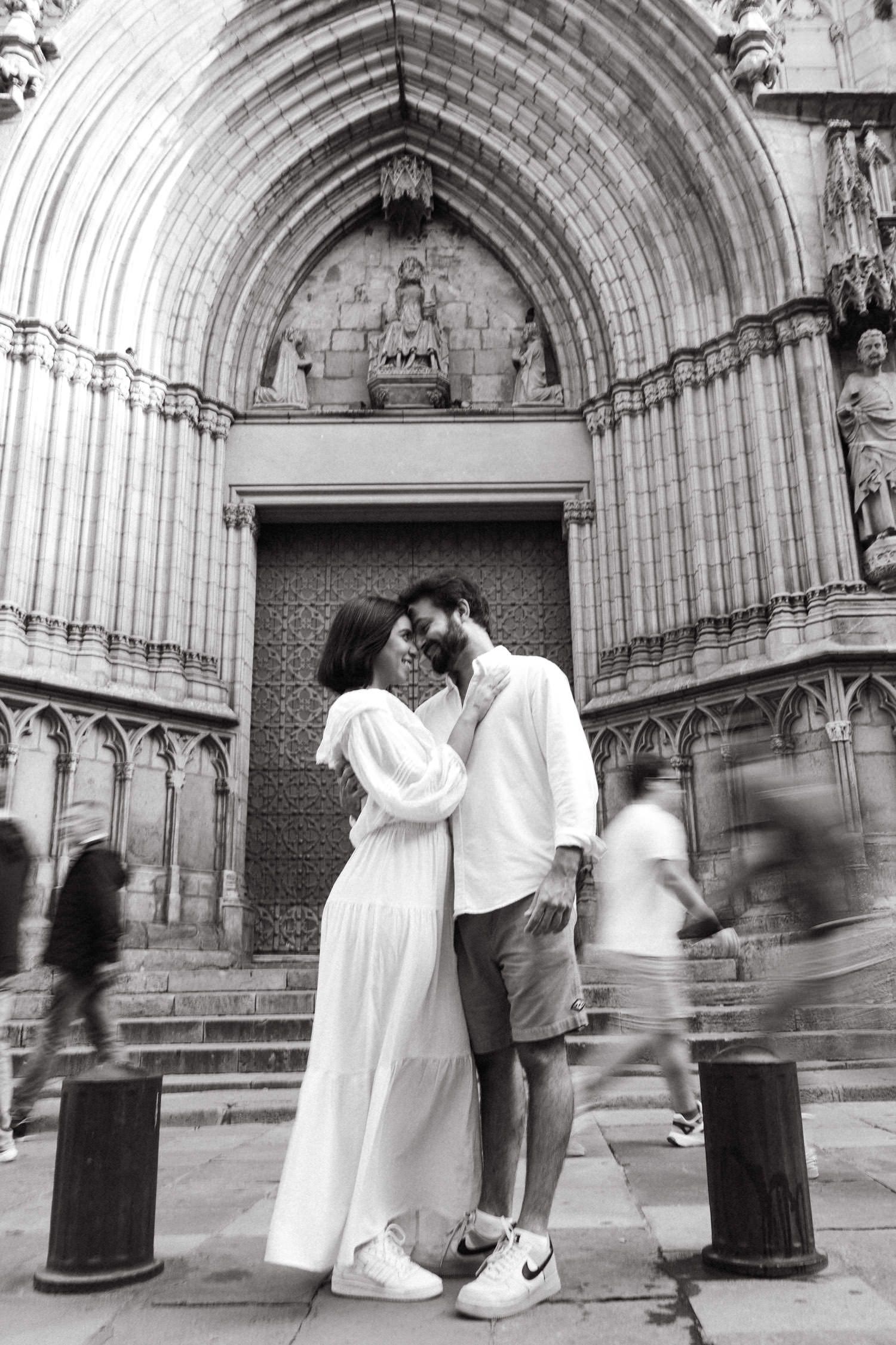 A romantic sequence of black and white photos showing a couple by a gothic church entrance.