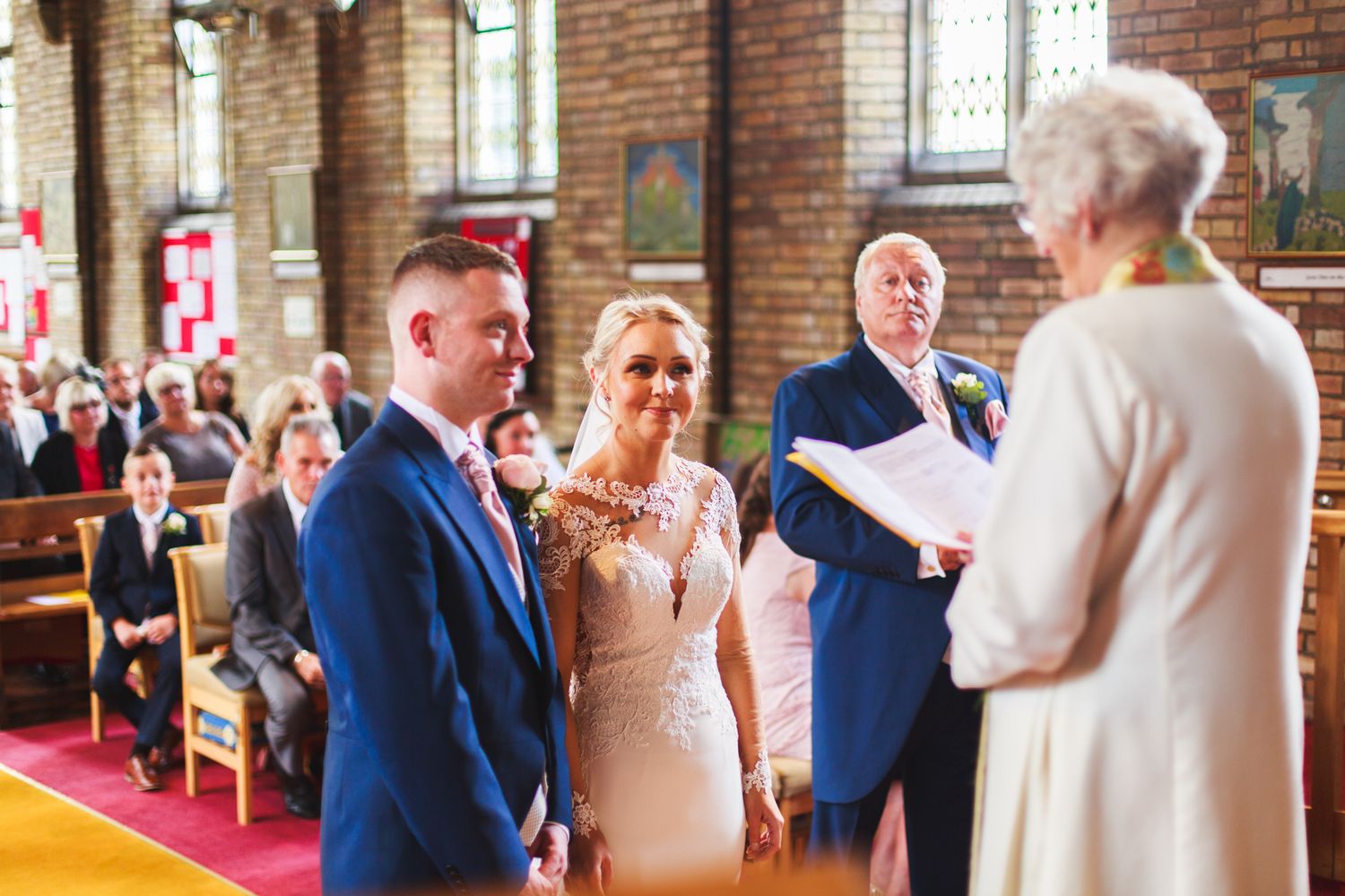 A series of wedding reception photos showing guests dancing and celebrating in a brick-walled venue.