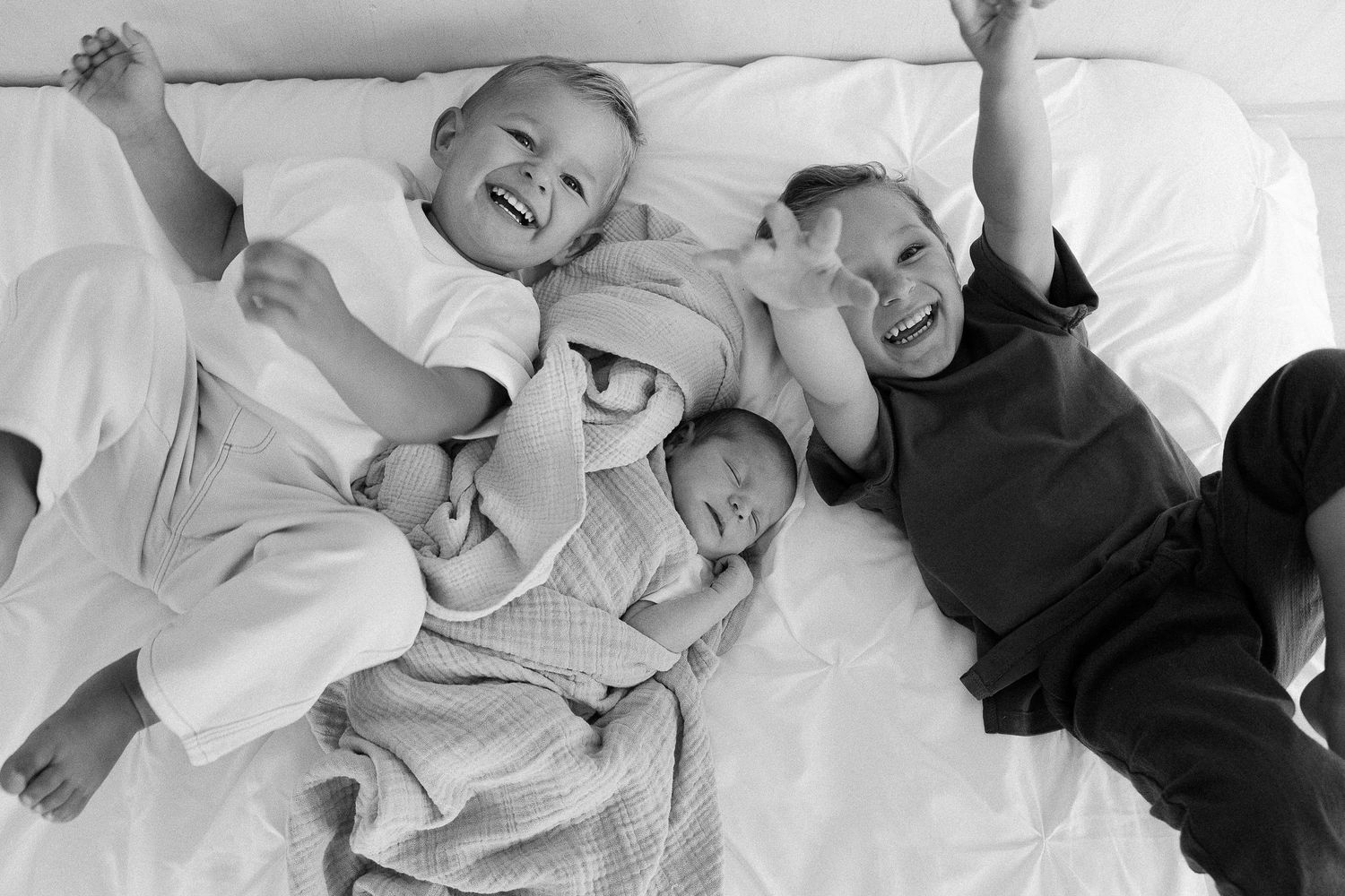A series of black and white photos showing joyful laughter and genuine emotional moments between people.
