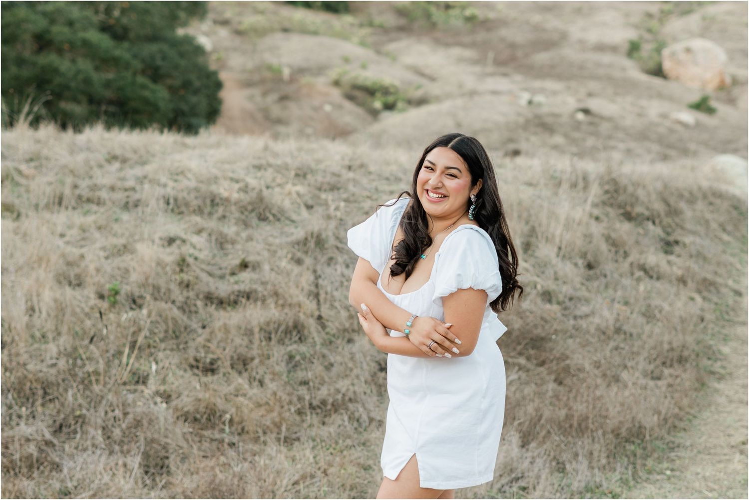 slo high senior session at Bishop's Peak wearing a white dress and boots for senior photos by Felisha Connolly photography