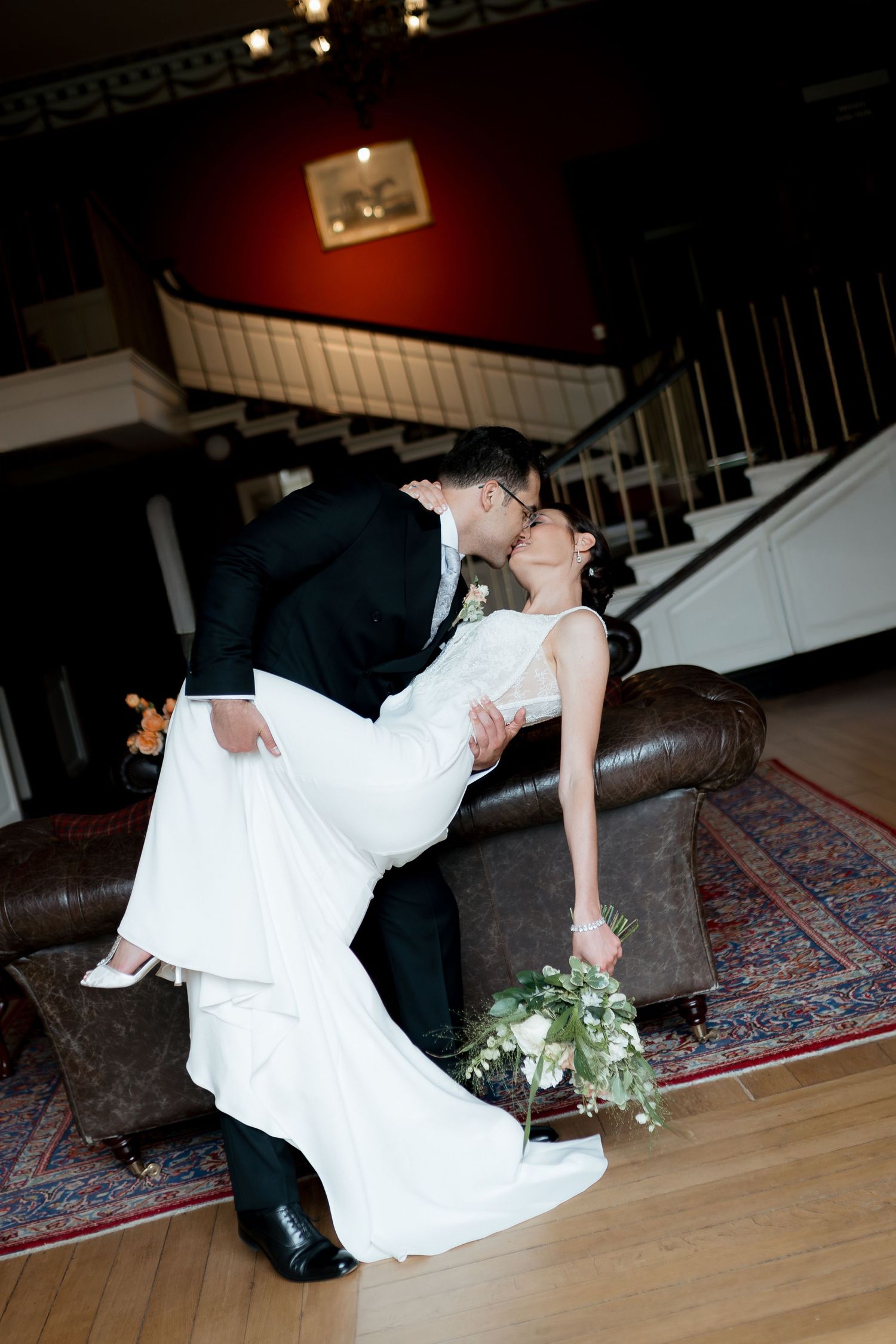 A sequence of romantic dance dip poses between a bride in white gown and groom in dark suit on an elegant carpeted floor.