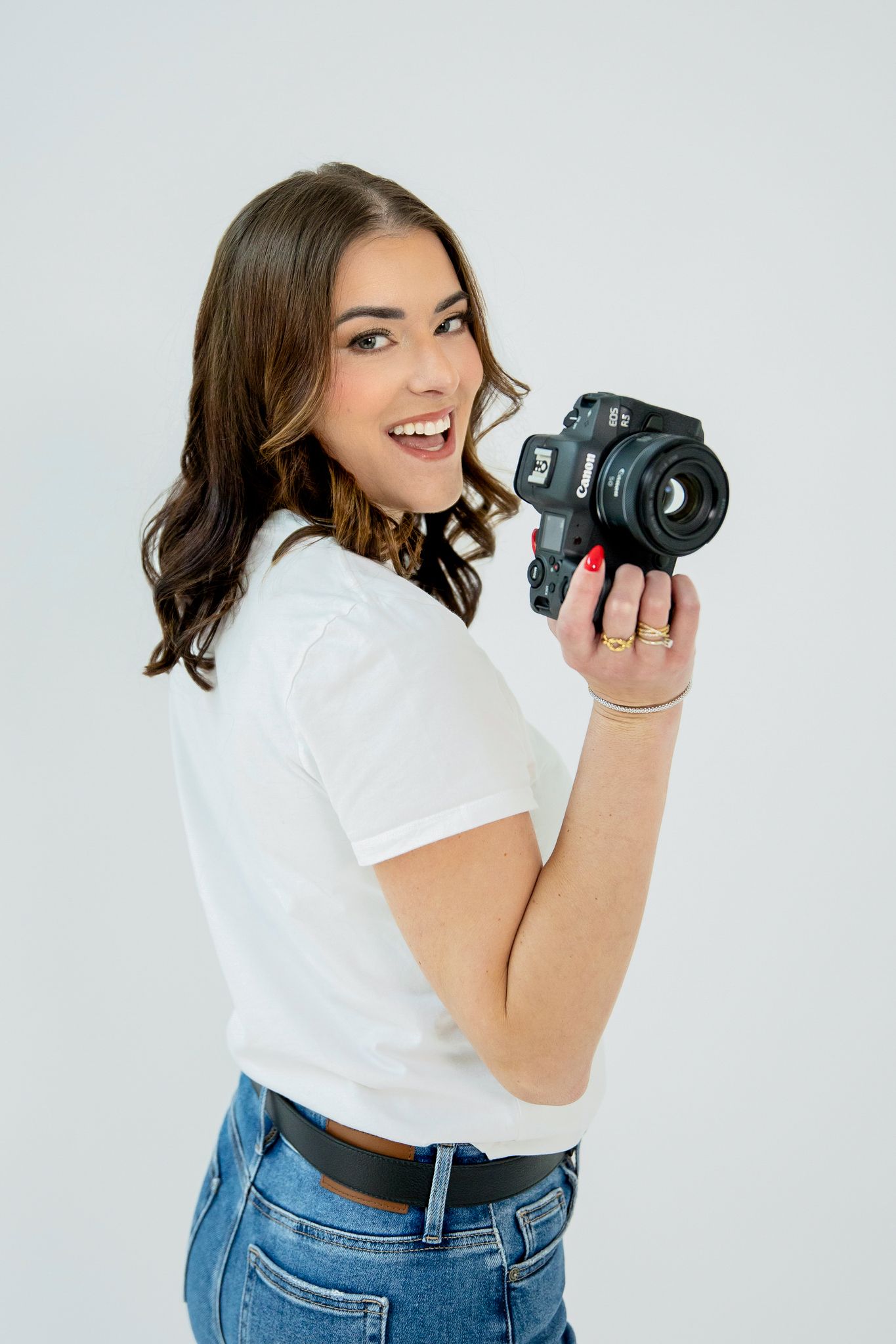 Brand photographer standing outdoors in a city holding a camera, emphasizing strategic brand photography and visual storytelling.