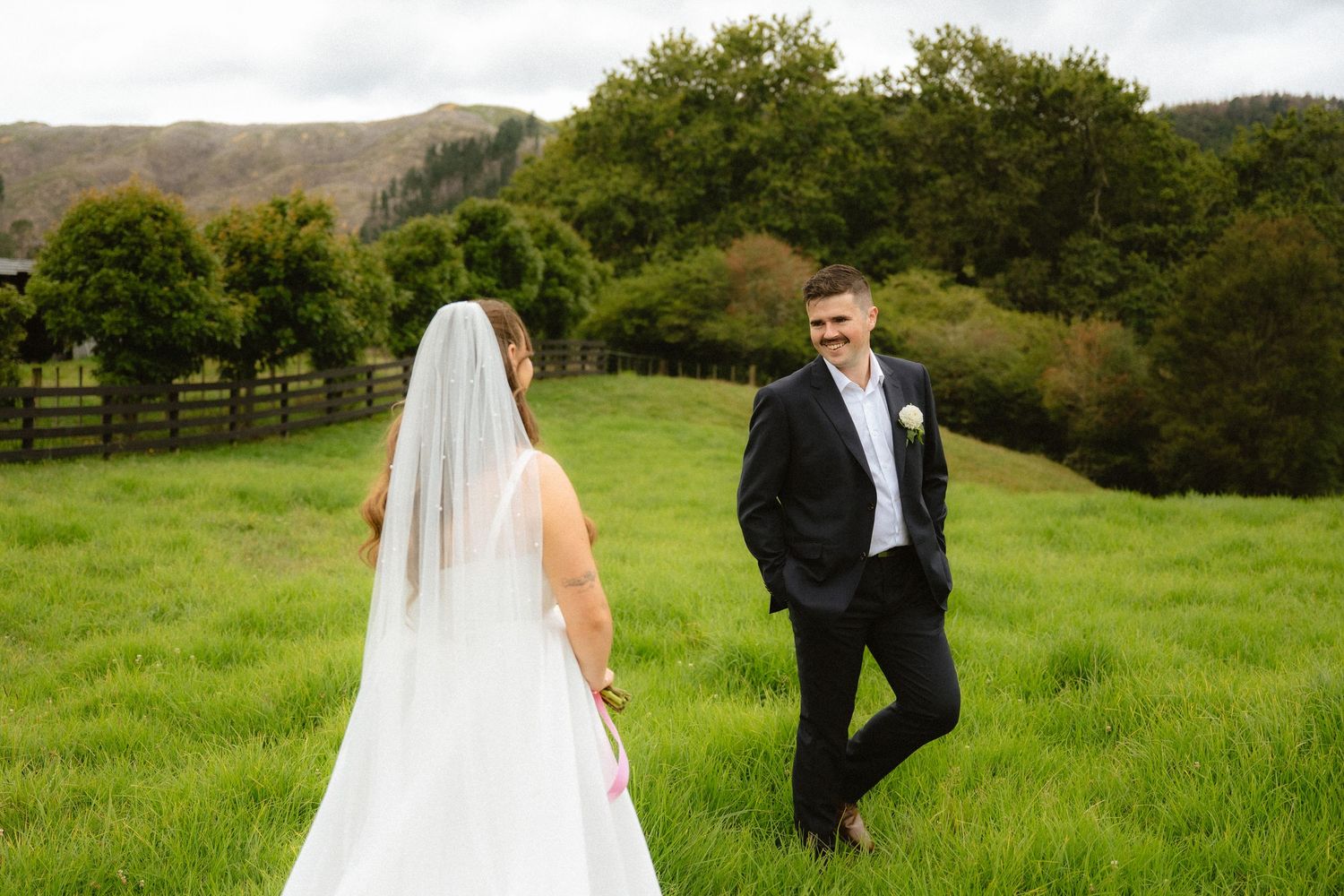 Delicate white veil flows in the breeze during an outdoor wedding ceremony.