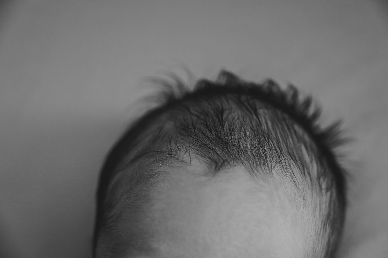 Newborn laying in fathers arms