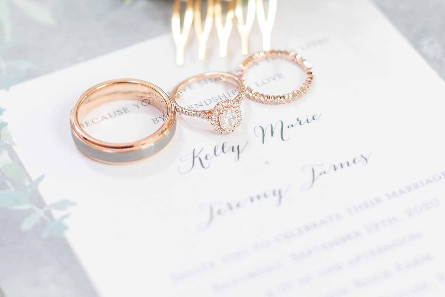 Wedding rings and stationery details photographed in soft, romantic lighting.