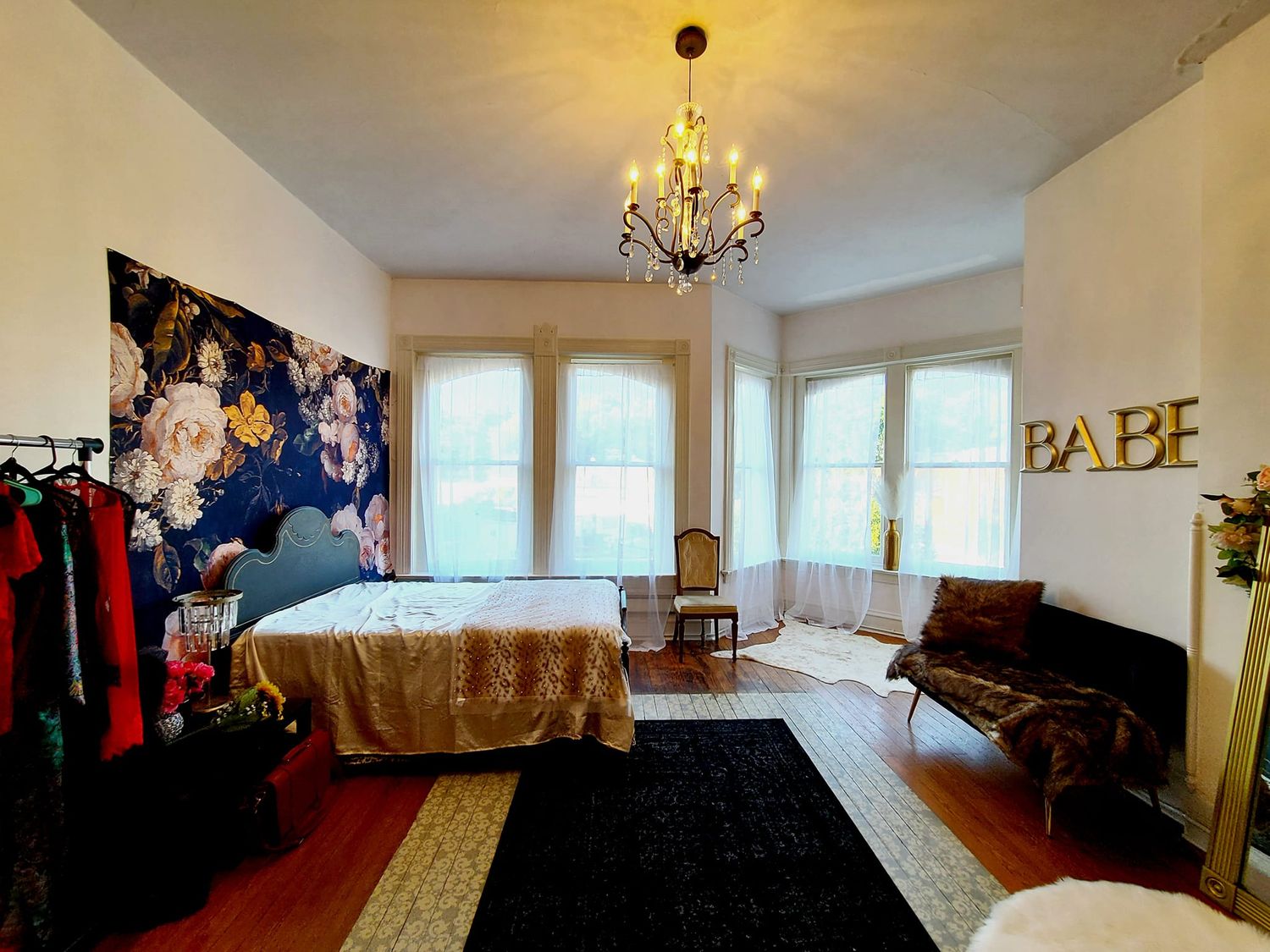 A beautiful boudoir studio with a chandelier, white walls and large windows in cape girardeau mo.