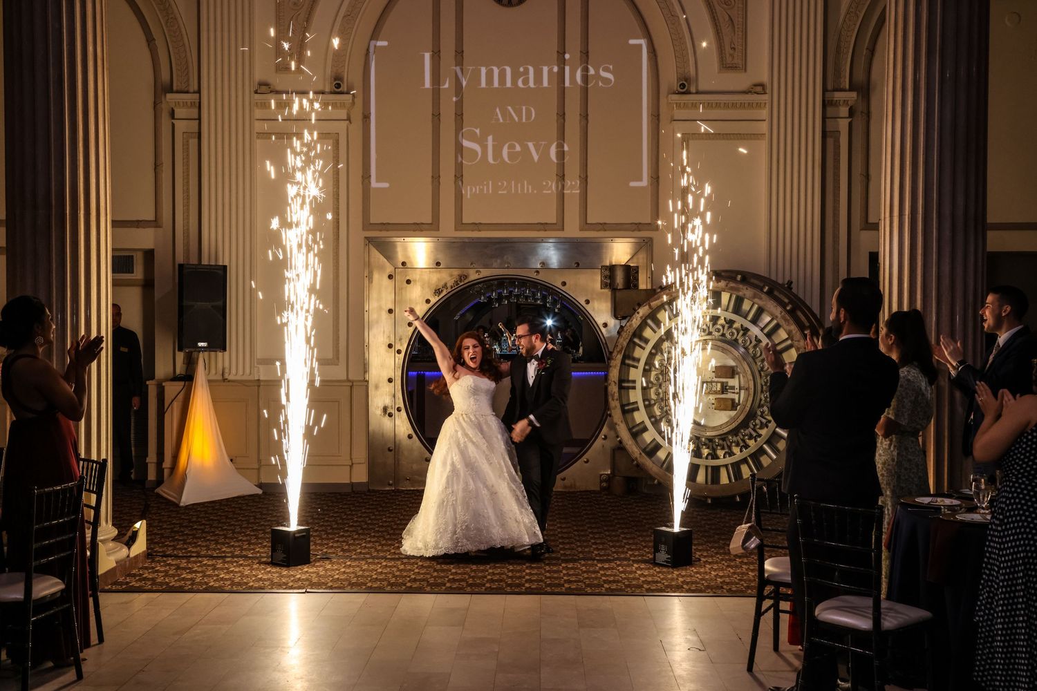A couple dances surrounded by dramatic sparkler fountains during their wedding reception.