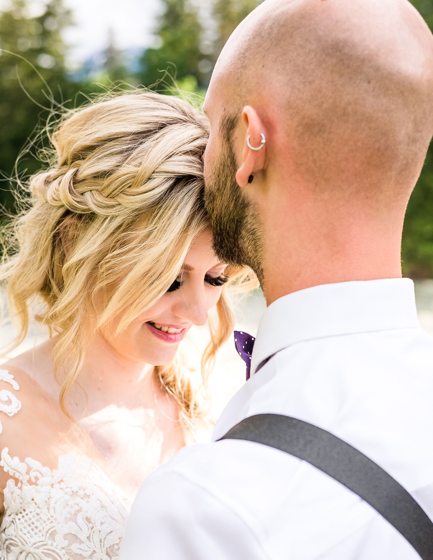 Groom kissing bride's forehead during wedding day portraits taken by Kari Mills Photography in Hope, BC.