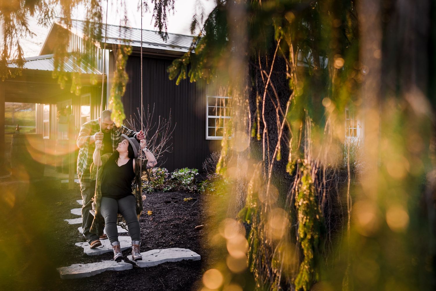 Sunlit outdoor scene with trees and buildings creating a dreamy natural backdrop.