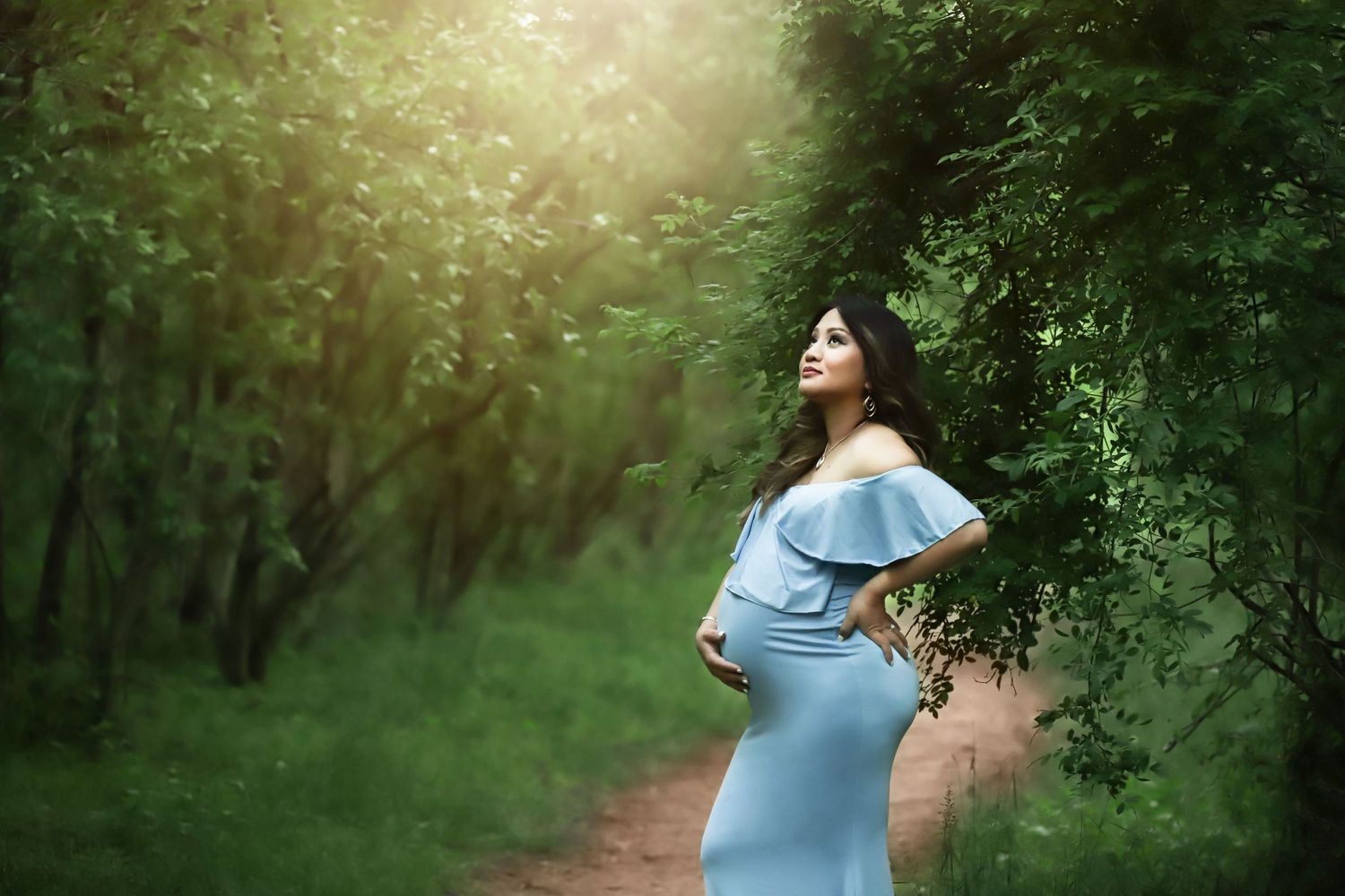 Fine art outdoor maternity portrait in Summer/Spring in the woods with long dress