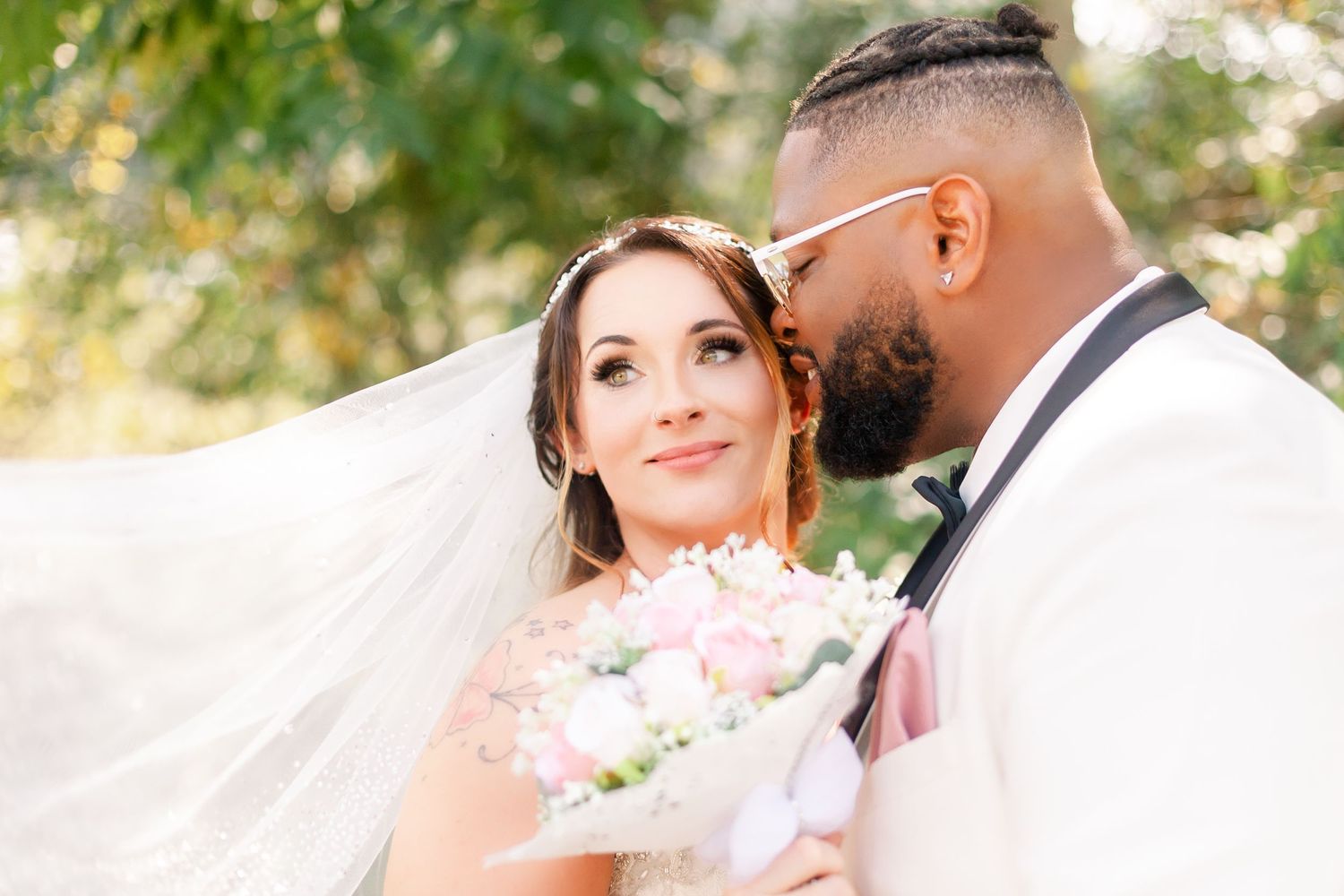 Romantic wedding portraits captured in soft natural lighting with elegant floral details.