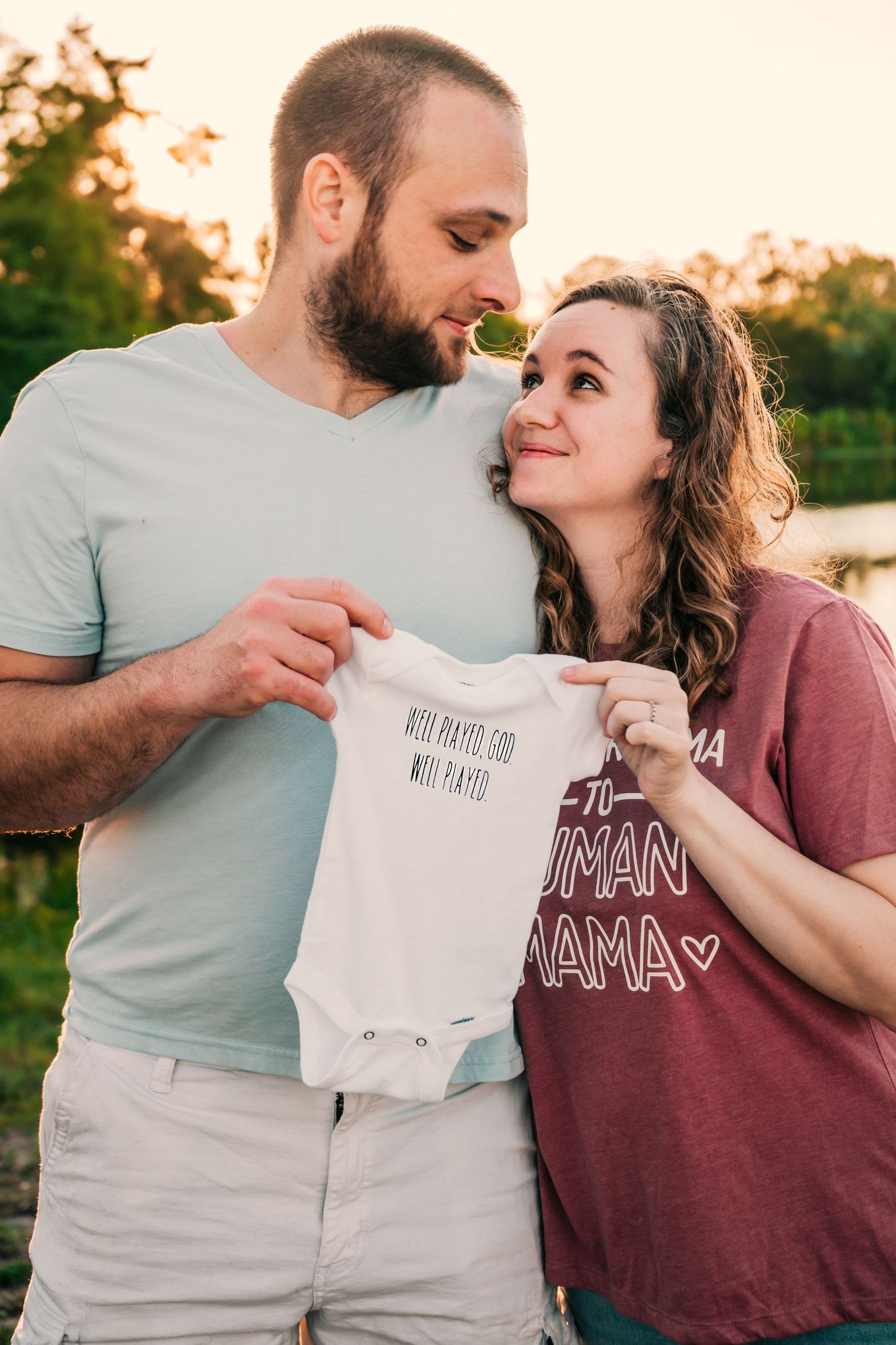 Outdoor Milestone Session at Walter Fuller Park, Pinellas Park, FL; Pregnancy announcement, couple with onesie announcing pregnancy