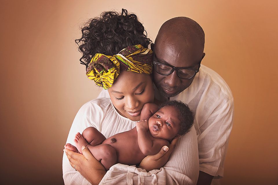 Intimate family portrait series with warm lighting and neutral tones.