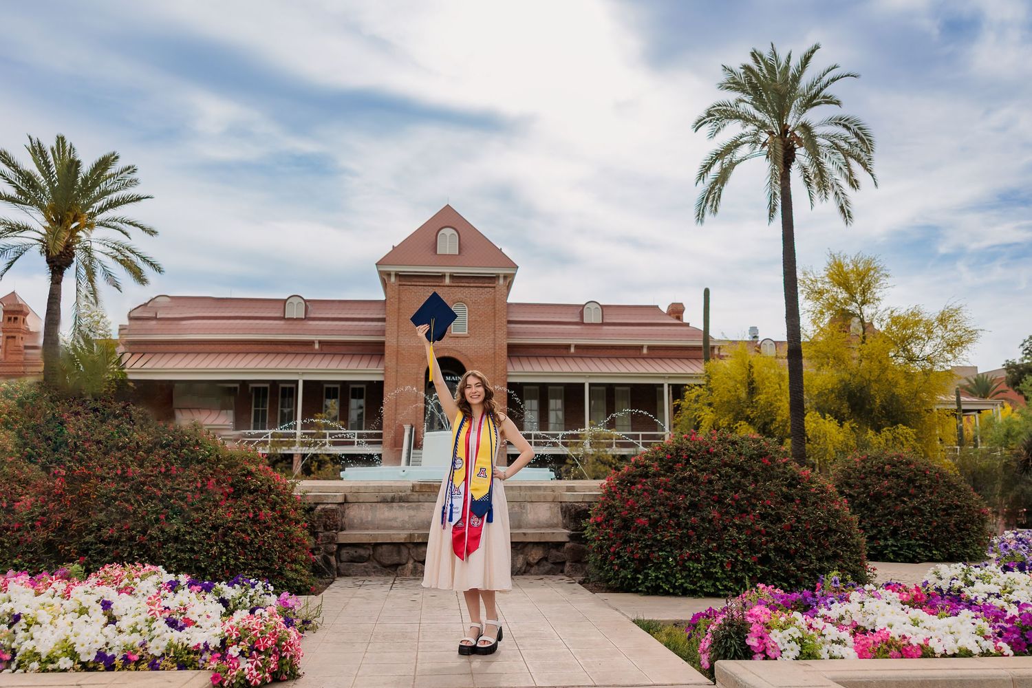 University of Arizona grad posing in front of Old Main Tucson, AZ