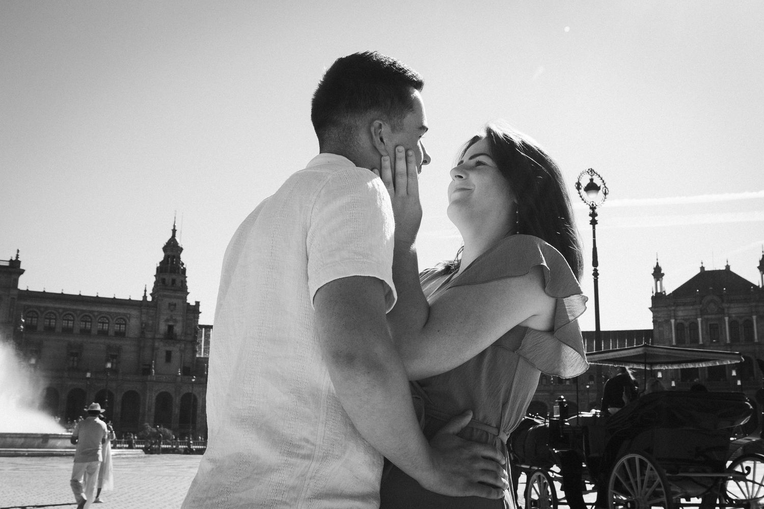 A romantic black and white photo series of a couple embracing in various scenic outdoor locations.