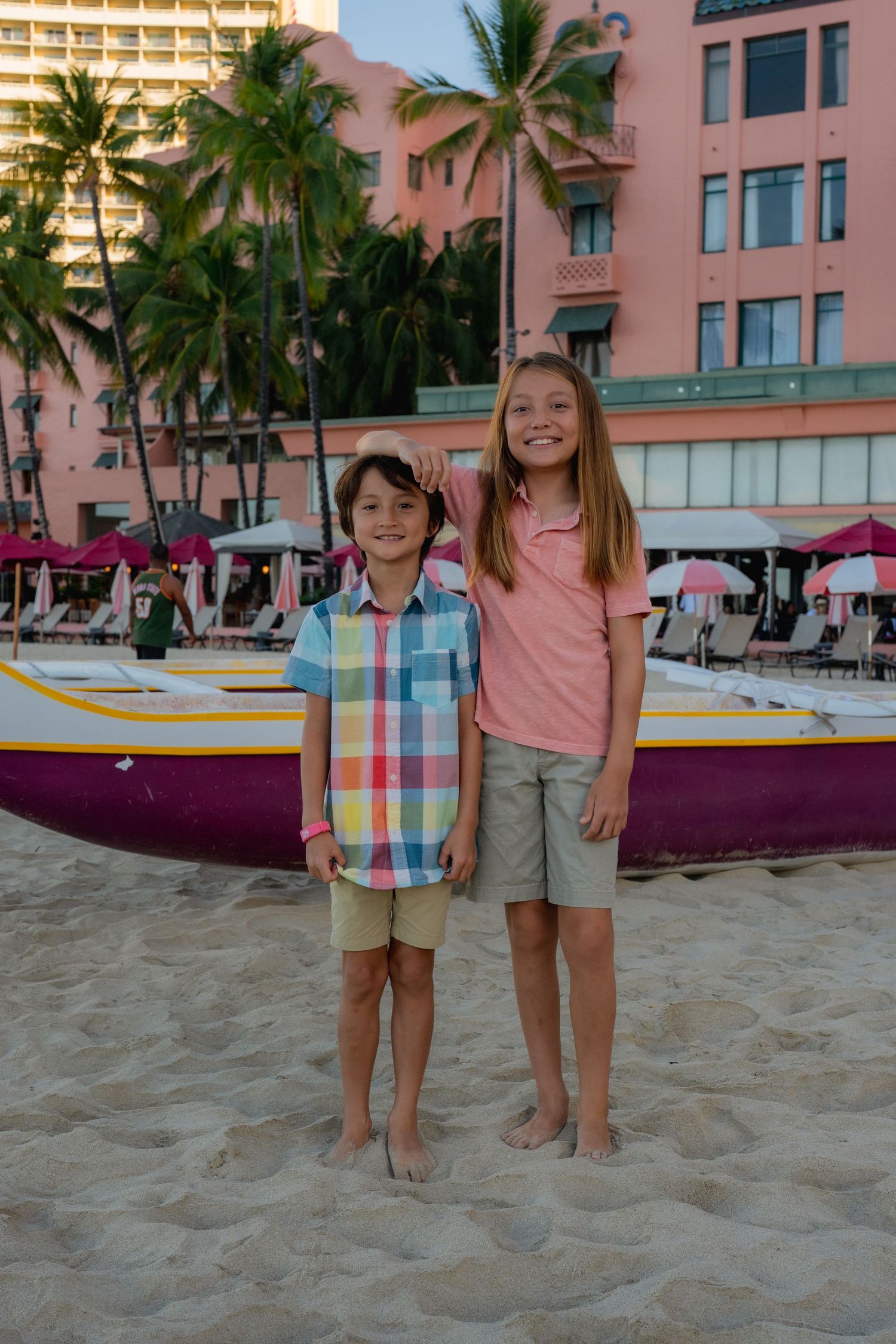 family on waikiki beach posing for a photo