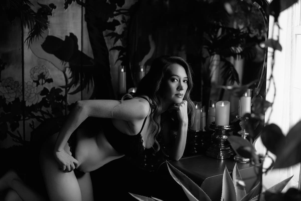 A series of black and white photographs showing silhouettes and intimate moments in dramatic lighting and shadows.