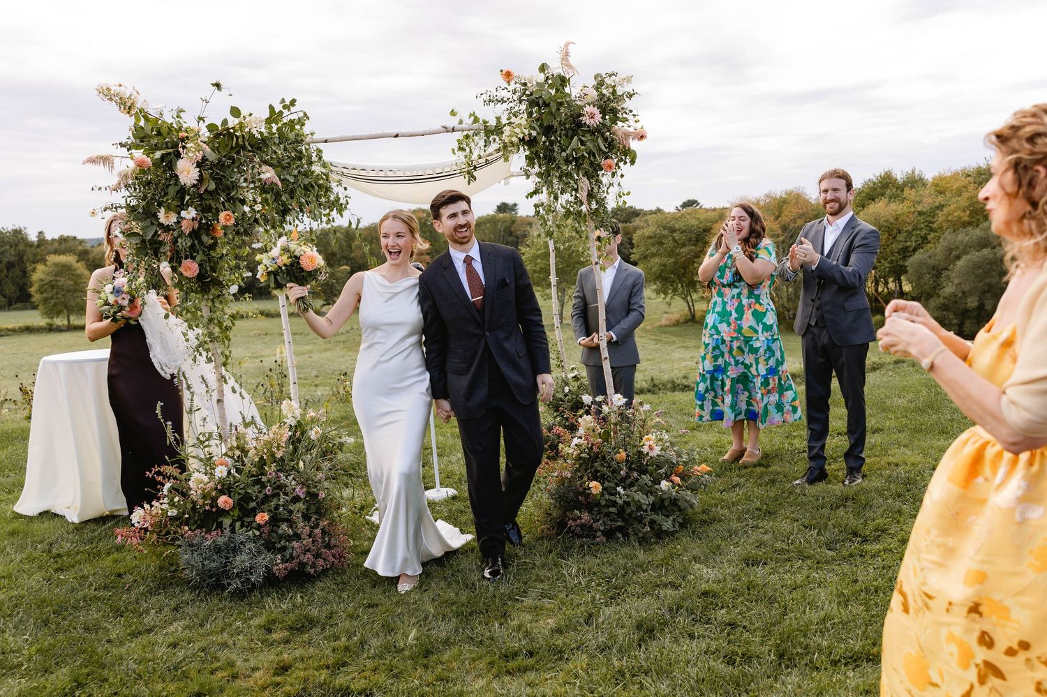 A couple exits after their first kiss and ceremony. Weatherlow Farm wedding. Westport Massachusetts.