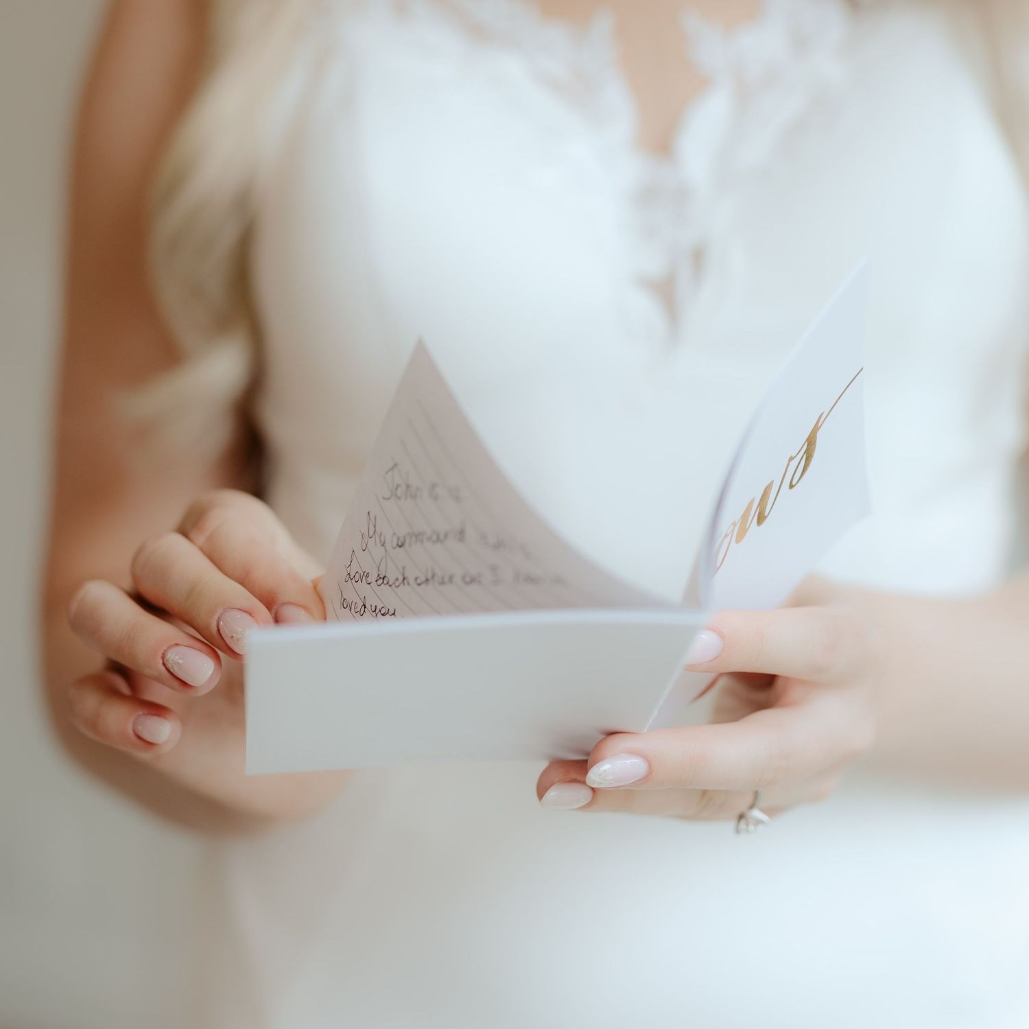 Close-up of bride with handwritten wedding vows
