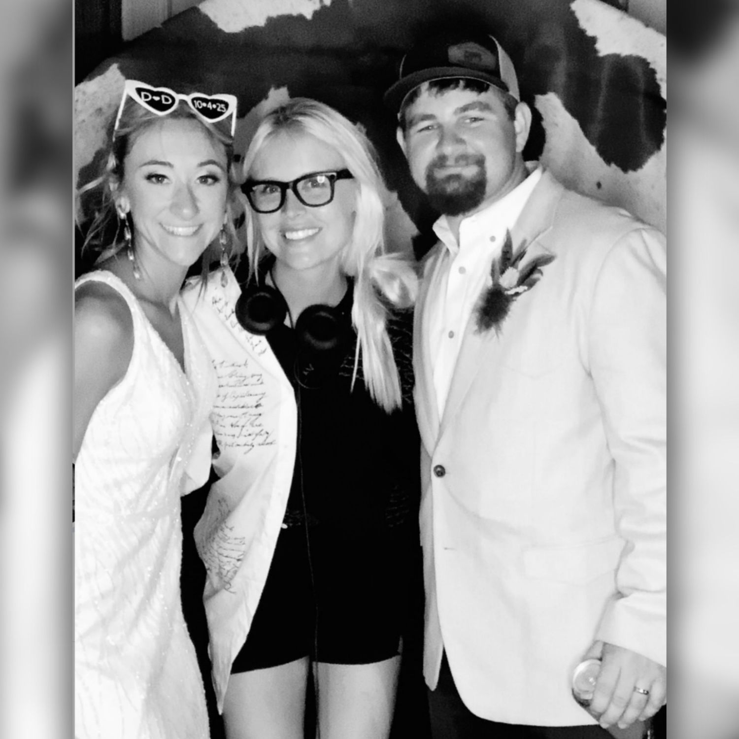 Black and white photo strip showing four candid party photos with people posing and smiling together.