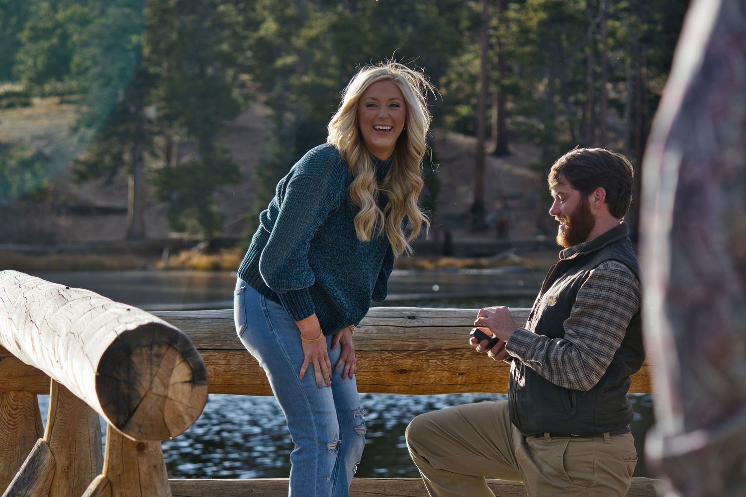 Man proposing to woman at Sprague Lake dock. Pixcapades | The Rocky Mountain Proposal Photographer