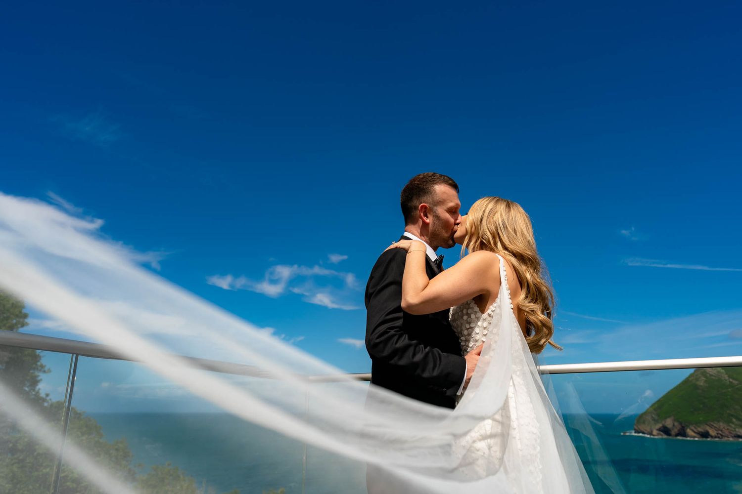 Newly married couple in front of rustic farm house at Ash Barton Estate in North Devon.
