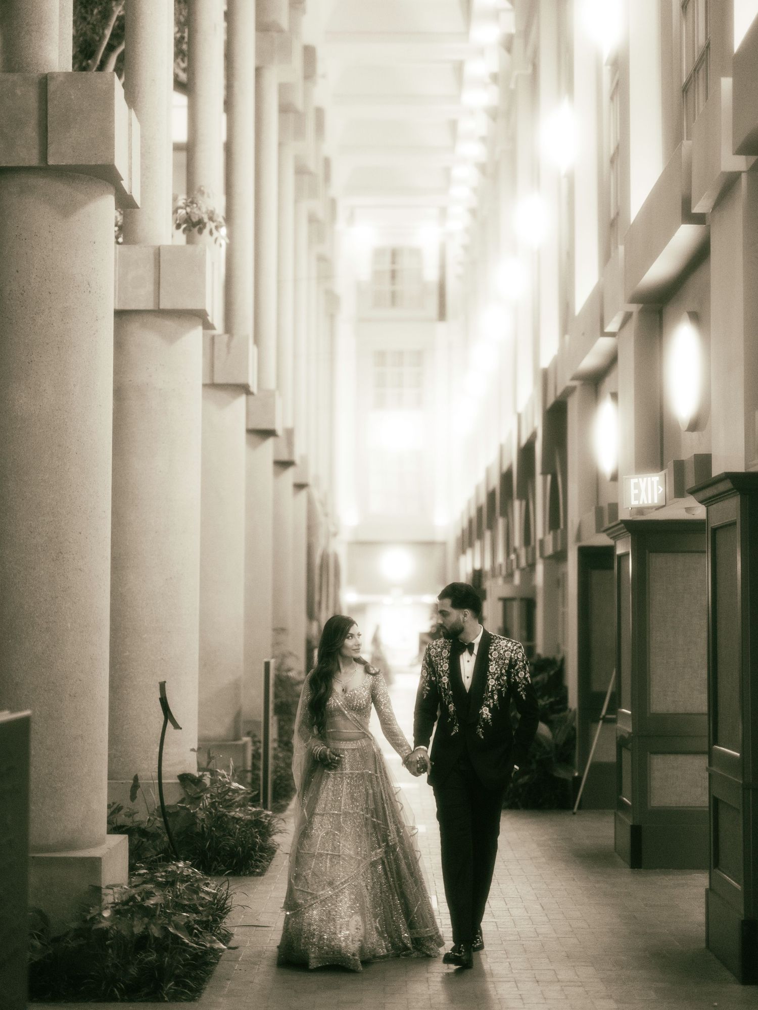 A series of five black and white photos showing a long corridor with white columns and dramatic shadows.