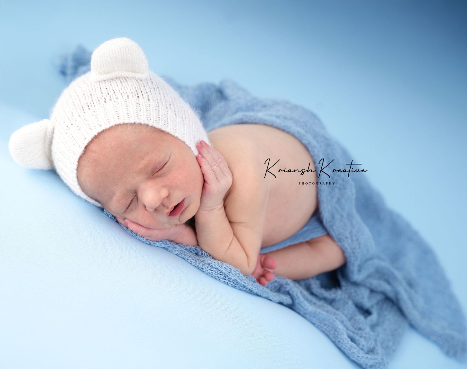Reverse froggy pose for newborn baby in baby blue tones