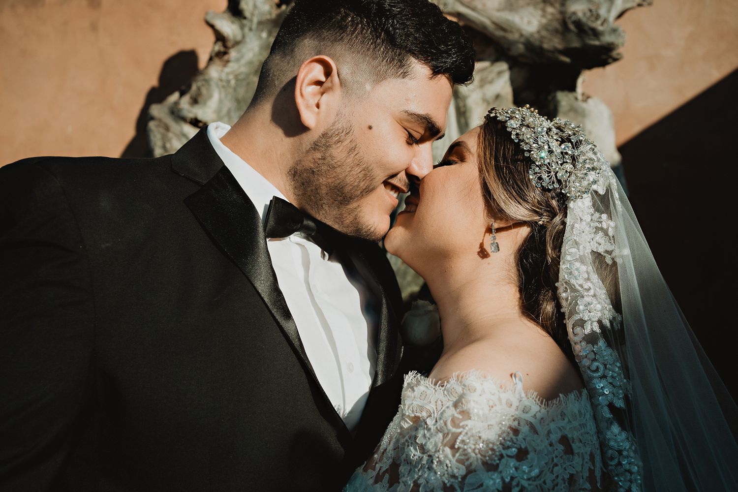 Almost a kiss between the couple, smiles reflecting happiness and closeness