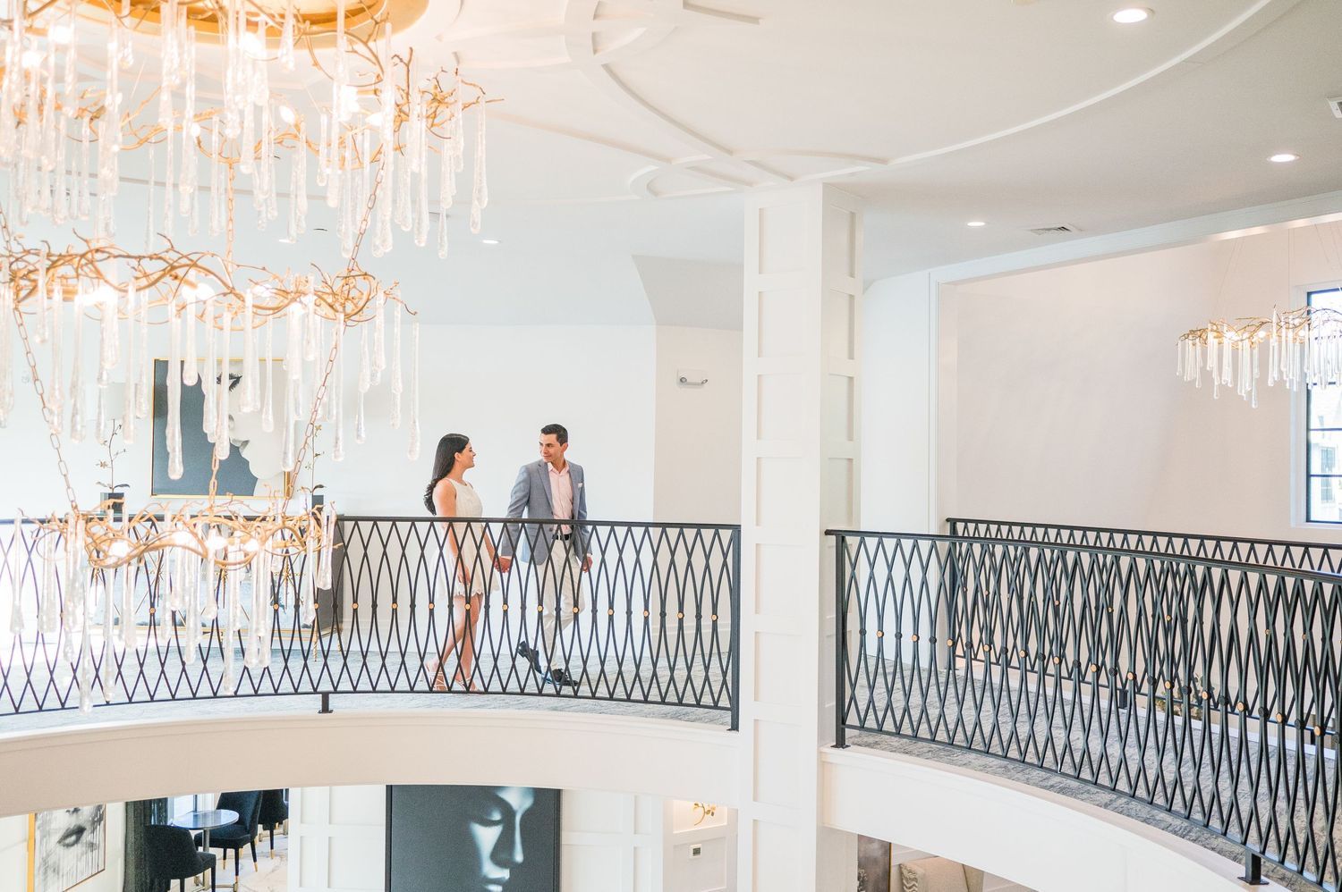 An affectionate couple walking hand-in-hand along the charming corridors of Water's Edge
