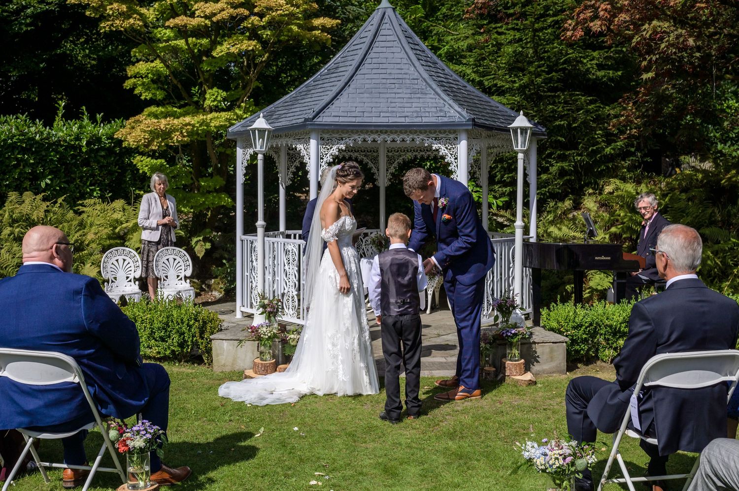 Best man offering rings to bride and groom at Broadoaks Counry House