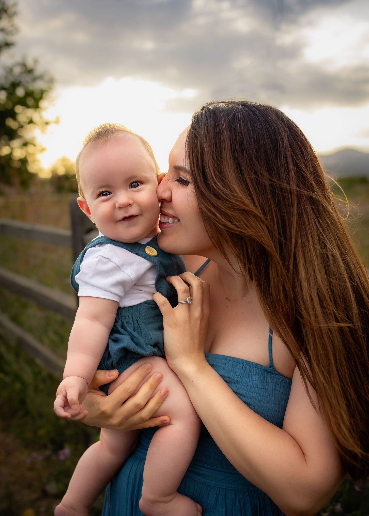 mom nuzzles baby's cheek at HVH Specialty Growers in Fairfield, CA