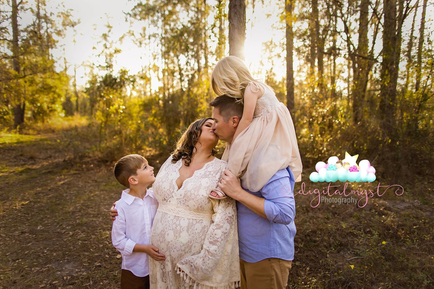 Outdoor family photoshoot in wooded area during golden sunset.