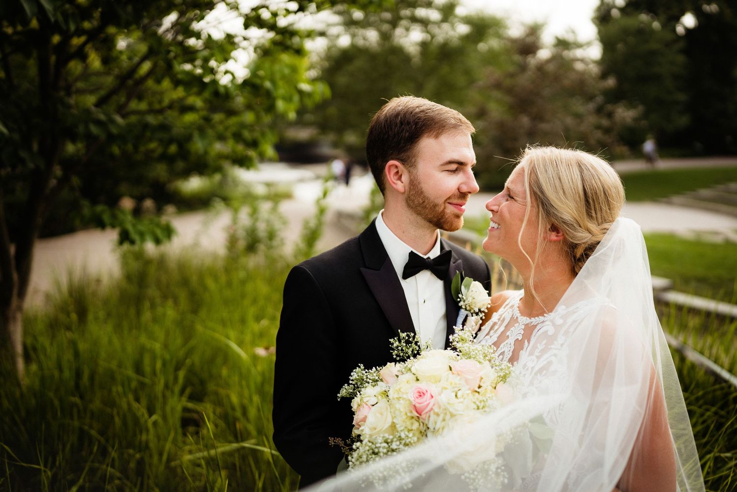 A romantic outdoor wedding portrait with delicate bouquet details.