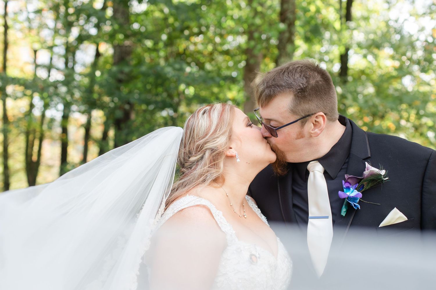 Romantic outdoor portrait session in a wooded area during fall season.