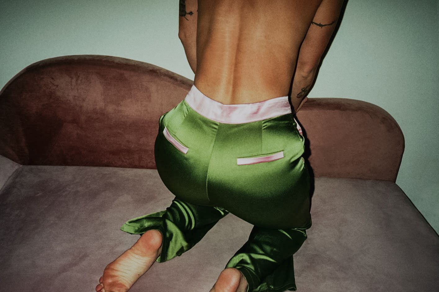 35mm film fashion portrait of woman in her home dressed in chartreuse pants