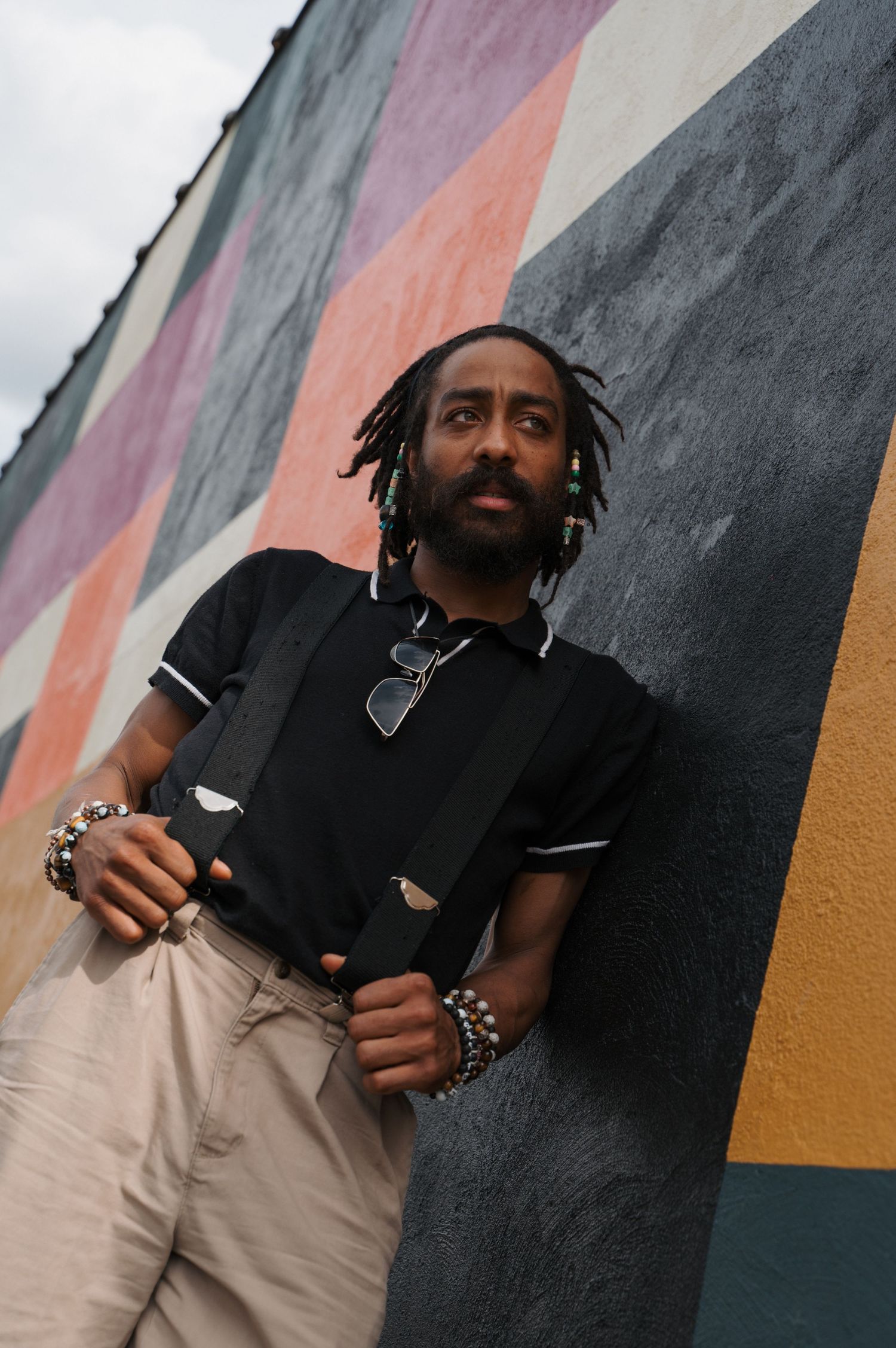 Stylish portrait against colorful geometric mural wall.