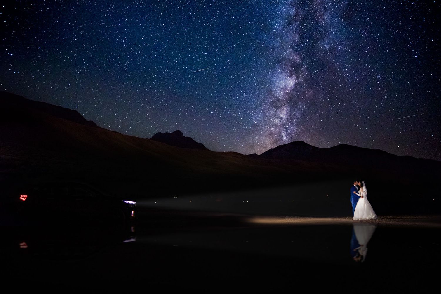 Stunning nighttime wedding photos against a starry mountain landscape.