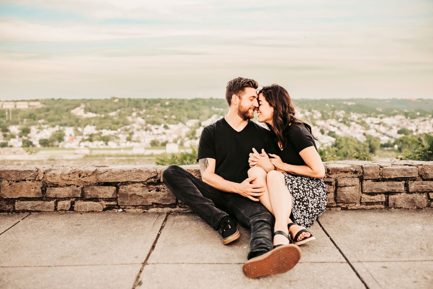 couple snuggles together overlooking the ohio river at eden park