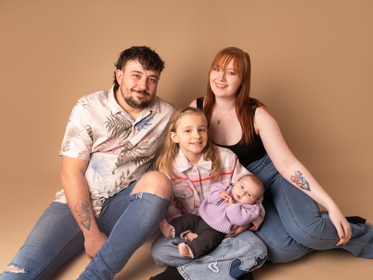 Family sitting for portrait updated photos with mum, dad, and two daughters for family session in Doncaster.