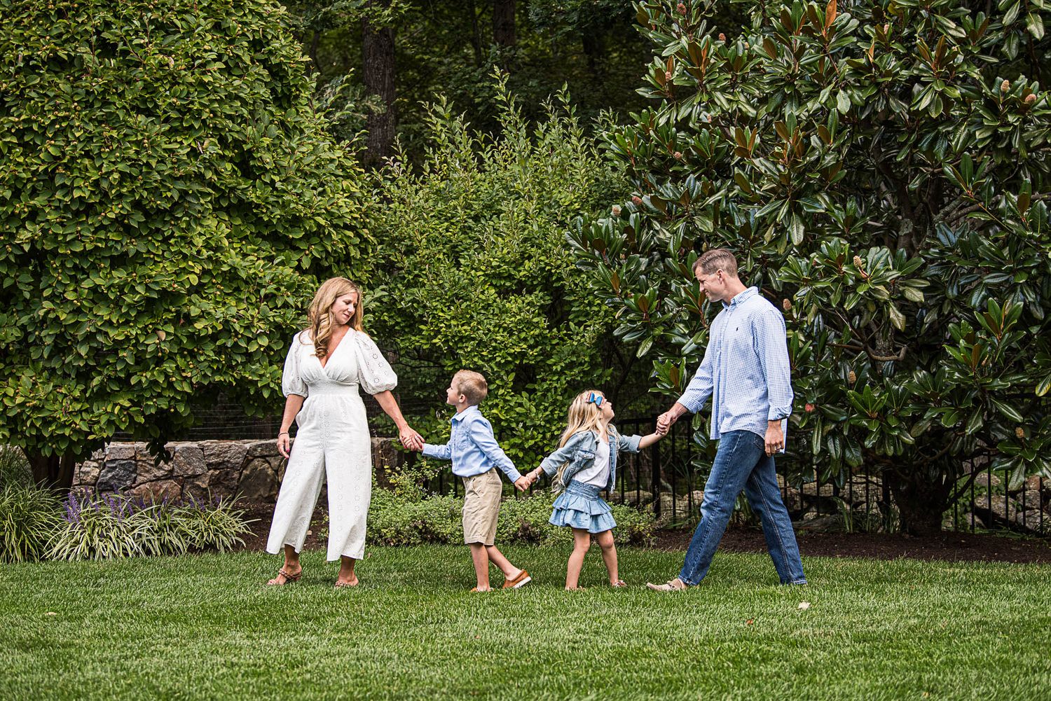 Family of 4 walking in their backyard